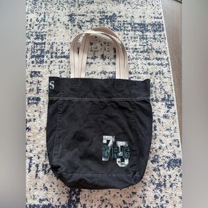 Garage Black Canvas Tote with Cream Straps and Teal Accents